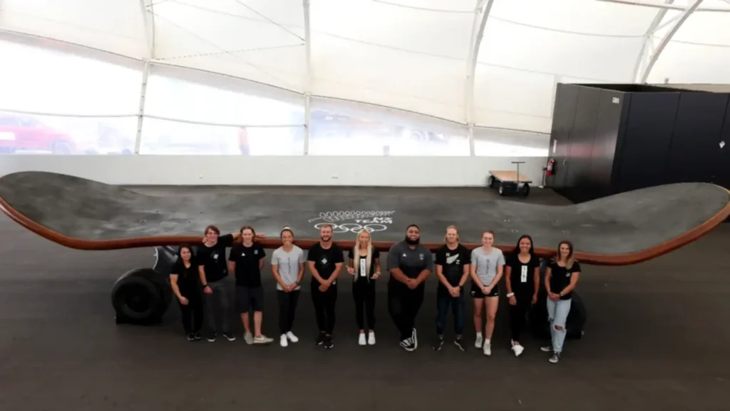 NZ Olympic team in front of giant skateboard